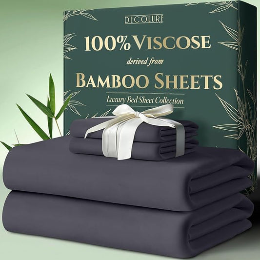 Dark grey bamboo viscose sheet set folded neatly with white ribbon, displayed next to green packaging box.