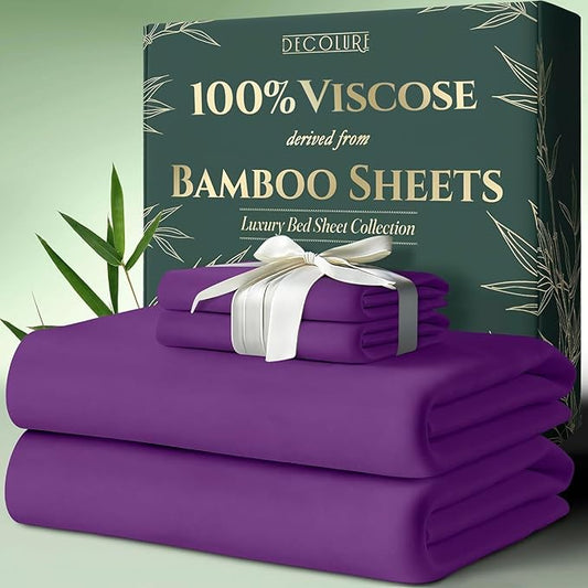 Purple bamboo viscose sheet set neatly folded with white ribbon, displayed alongside green packaging box with text.