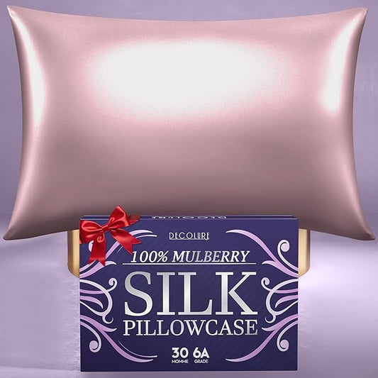 Coral silk pillowcase with smooth, shiny finish displayed above a purple box with red ribbon and white text.