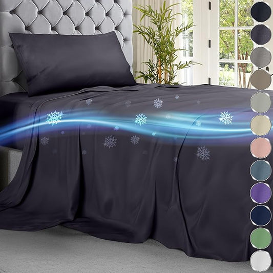 Graphite cooling sheet set on bed with tufted gray headboard and blue cooling effect illustration.