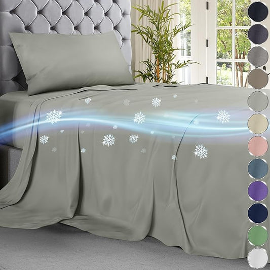 Light grey cooling sheet set on tufted grey headboard bed with digital snowflake and air flow graphics.