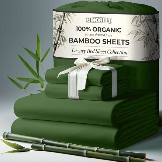 Olive green bamboo sheet set with neatly folded sheets, pillowcases, and tied with white ribbon.