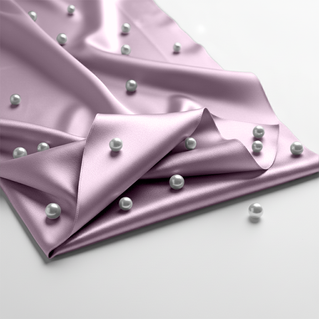 Lavender satin fitted sheet with smooth sheen and scattered white pearls on fabric.