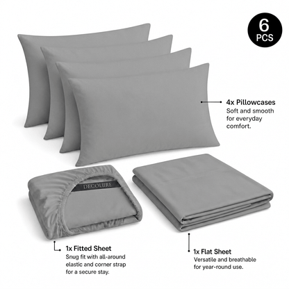 Light gray Decolure sheet set shown as 6 pieces: 4 pillowcases, one folded fitted sheet and one folded flat sheet.