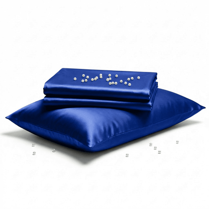 Blue satin pillowcase with a folded blue satin sheet on a white background