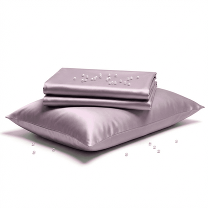 Purple satin pillowcase and sheet set on a white background
