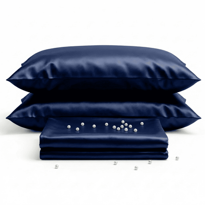 Set of navy satin pillows and a matching pillowcase on a white background