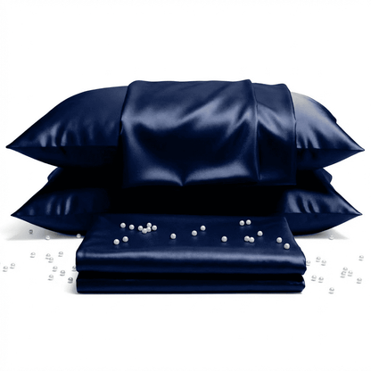Set of navy satin pillows and pillowcases on a white background