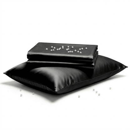 Black satin pillow and pillowcase on a white background