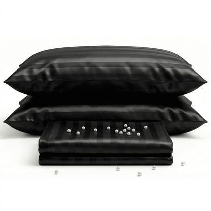 Black satin pillowcases with a small pillow on a white background