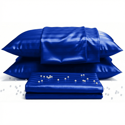 Blue satin pillowcases and a matching mattress cover with pearls on a white background