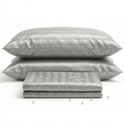 Gray satin pillowcases with a subtle pattern on a white background