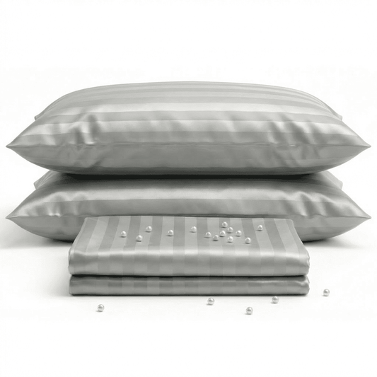Gray satin pillowcases with a subtle pattern on a white background