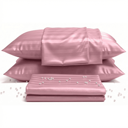 Pink satin pillowcases and sheet set with pearls on a white background