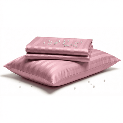 Pink satin pillowcase with pearls on a white background