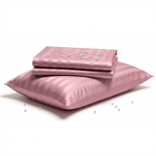 Pink satin pillowcase with pearls on a white background