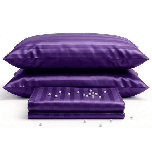 Purple satin pillowcases with pearls on a white background