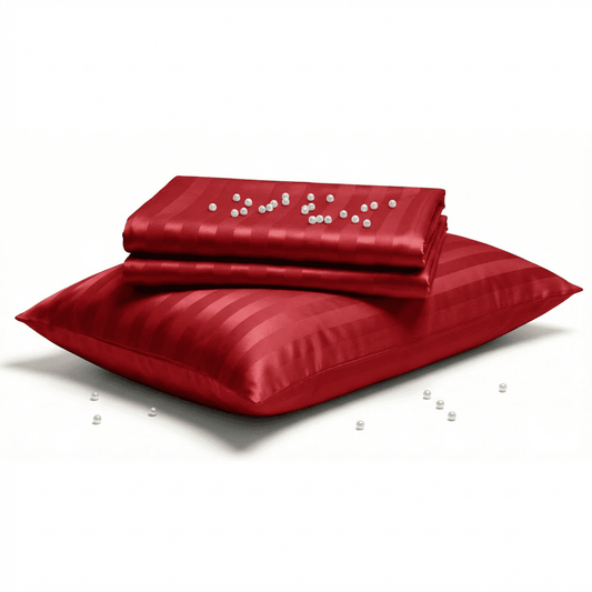 Red satin pillow and pillowcase set on a white background