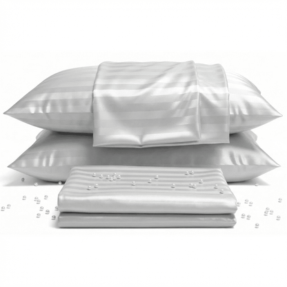 Set of white satin pillows and a sheet on a white background