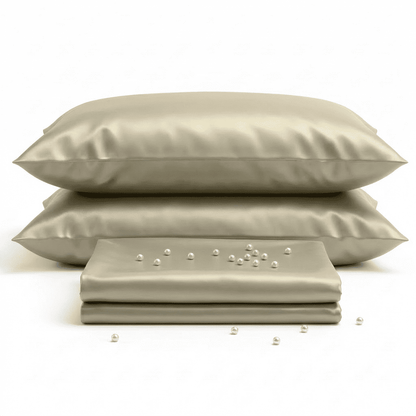 Beige satin pillowcases and fabric on a white background