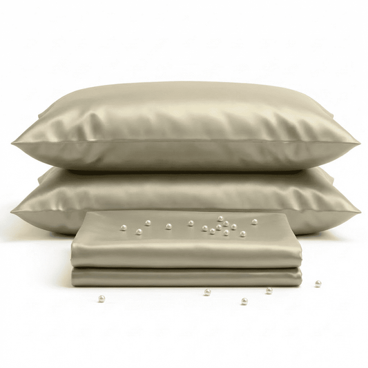 Beige satin pillowcases and fabric on a white background