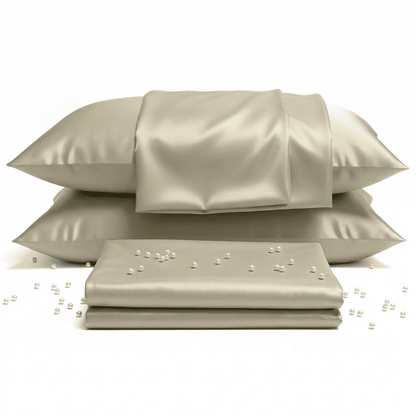 Beige satin pillowcases and sheet set on a white background