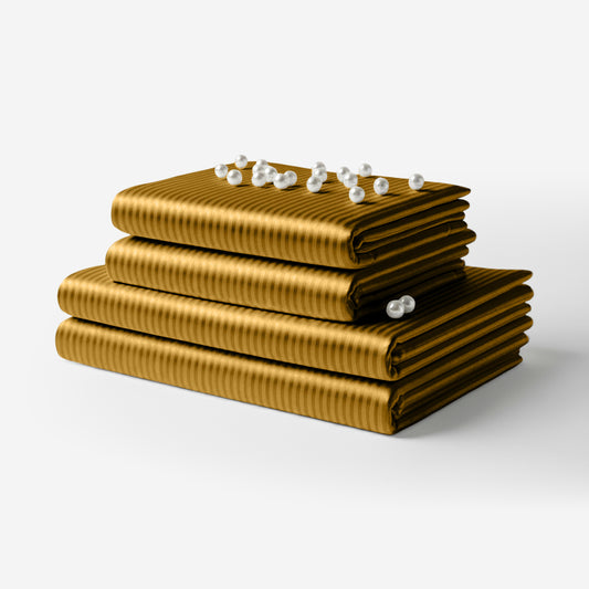 Stacked striped gold satin sheets with a smooth, glossy finish and subtle horizontal ribbed texture, decorated with small.