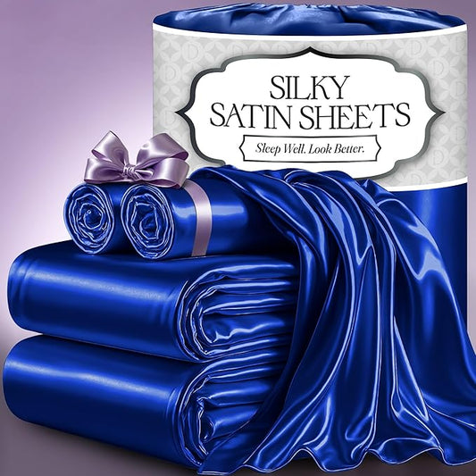 Luxurious blue satin sheet set with smooth, glossy finish and elegant texture, neatly folded and rolled with a matching.
