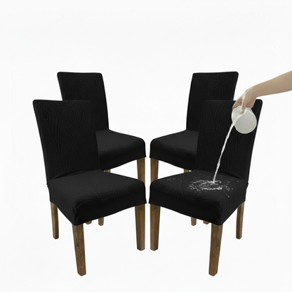 Black chair covers being tested for spill resistance with a white substance being poured.
