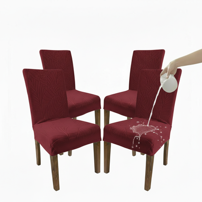 Red dining chairs with a water spill effect on one chair, on a white background