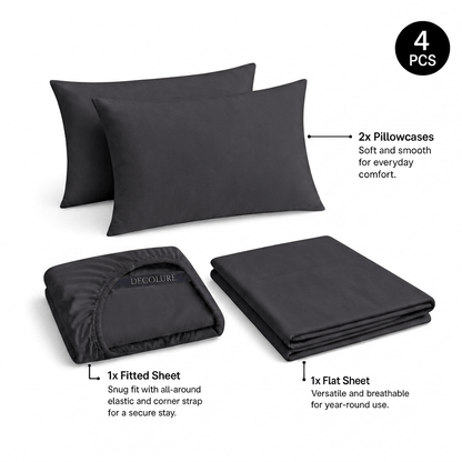 Charcoal gray Decolure sheet set shown as 4 pieces: 2 pillowcases, one folded fitted sheet and one folded flat sheet.