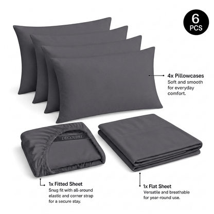 Gray Decolure sheet set shown as 6 pieces: 4 pillowcases, one folded fitted sheet and one folded flat sheet.
