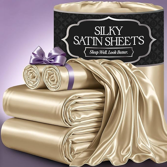 Ivory satin sheet set with smooth, glossy finish, includes fitted sheet, flat sheet, and pillowcases, displayed with one.