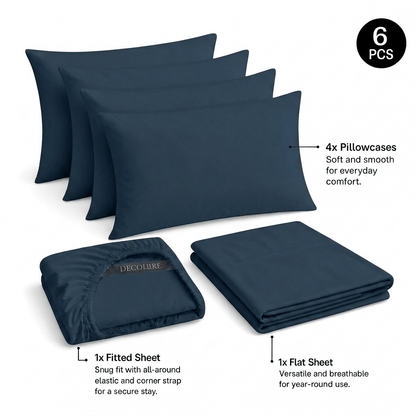 Navy blue Decolure sheet set shown as 6 pieces: 4 pillowcases, one folded fitted sheet and one folded flat sheet.