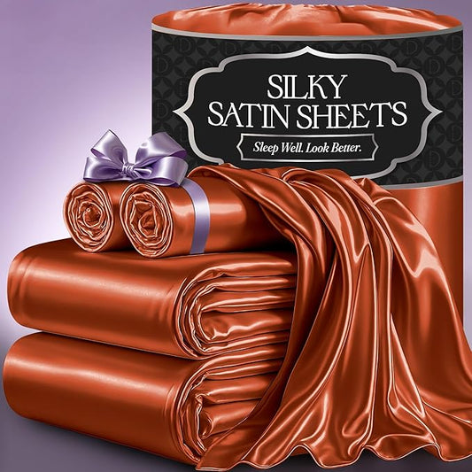 Burnt orange silky satin sheet set with smooth, glossy texture, neatly folded and rolled, labeled packaging.
