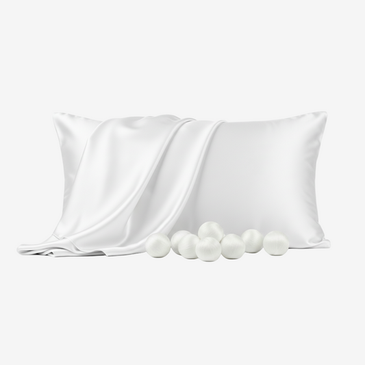 White silk pillowcase with smooth sheen, accompanied by soft silk cocoons on a white background.