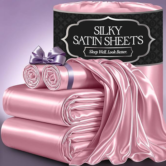 Pink satin sheet set with glossy finish, including folded sheets and rolled pillowcases, displayed with packaging bag.