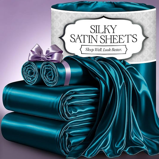 Sea teal silky satin sheets with matching rolled pillowcases and fitted sheet on a purple background.